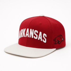 Red and white Arkansas Razorbacks flatbill snapback hat with bold white “ARKANSAS” embroidery and Razorback logo on the side.
